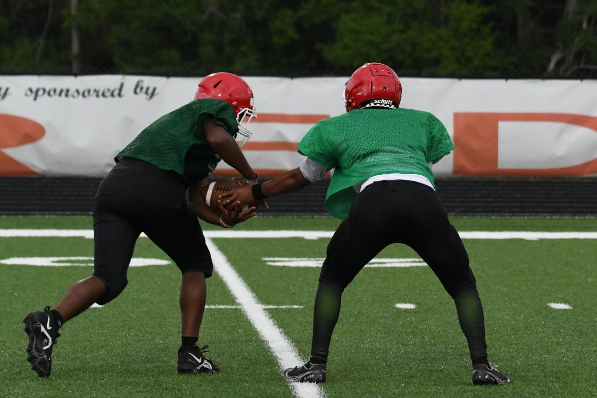 Anderson football players practice a play during the red-green scrimmage game on August 4.
