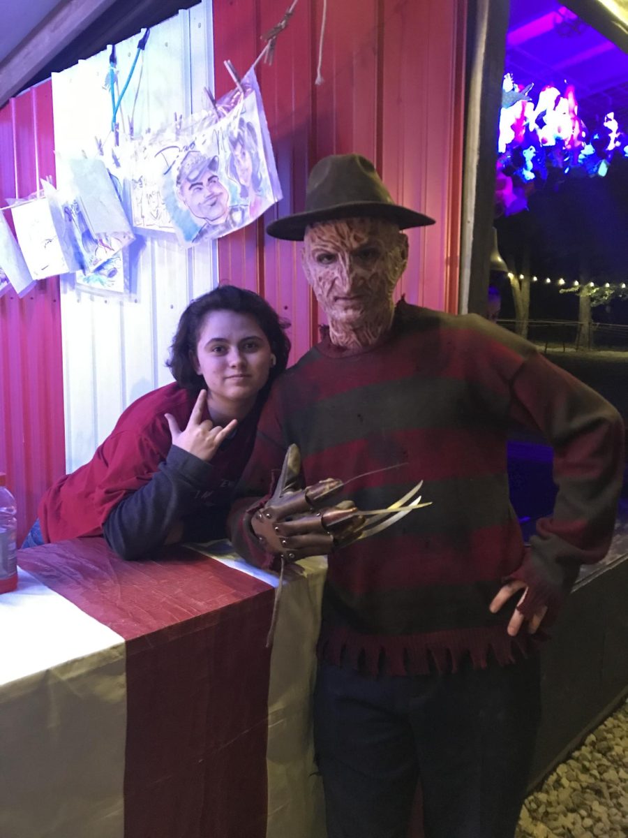 Senior April Diaz poses with a man in a Freddy Krueger costume at the Indy Scream Park in 2022.