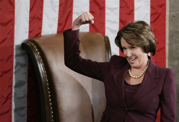 U.S. Representative Nancy Pelosi is seen standing in the chamber of the United States House of Representatives flexing her muscle as she address fellow member of Congress in January of 2009. 