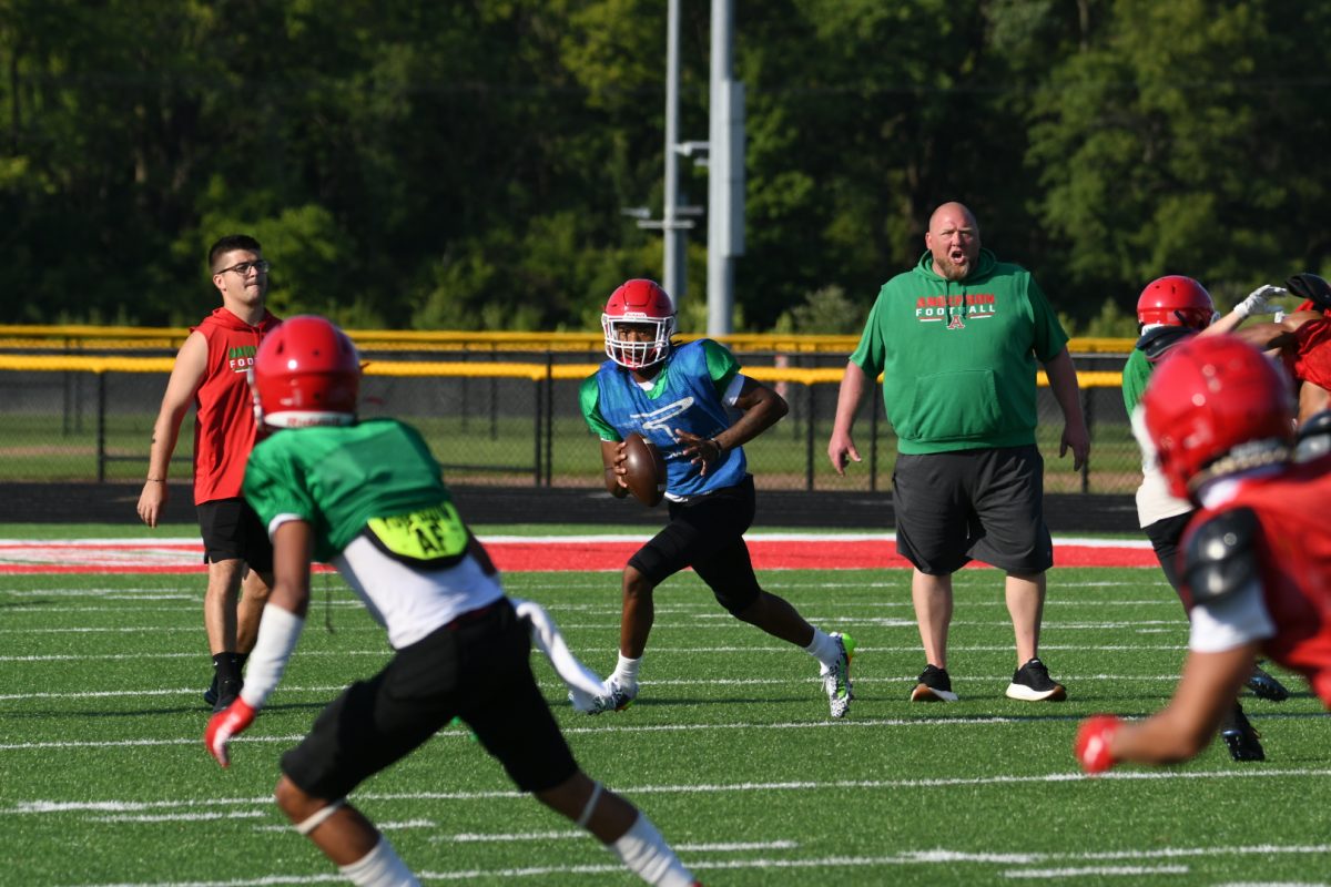 Coach Pennycuff drills his team on the field.