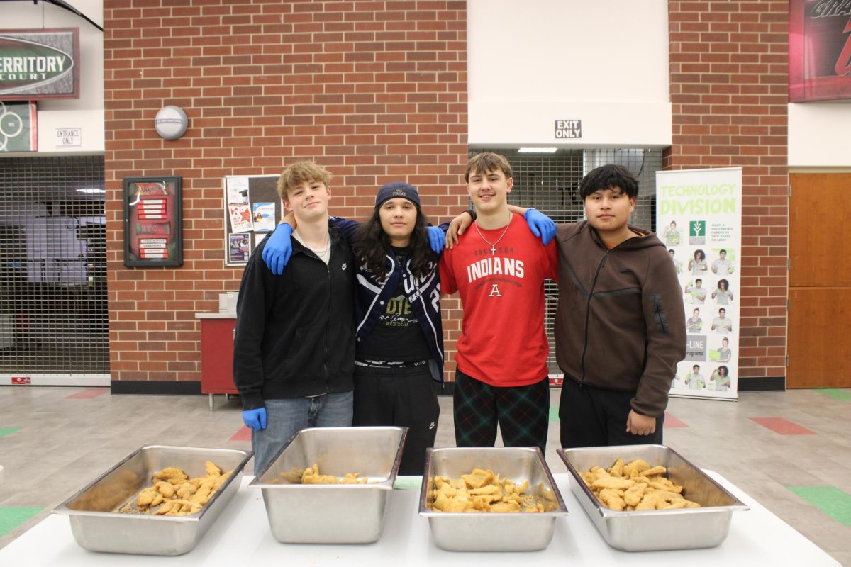 The AHS baseball team posed up for a photo after serving chicken to happy guests. They mentioned that their favorite part of the event was "meeting new people."