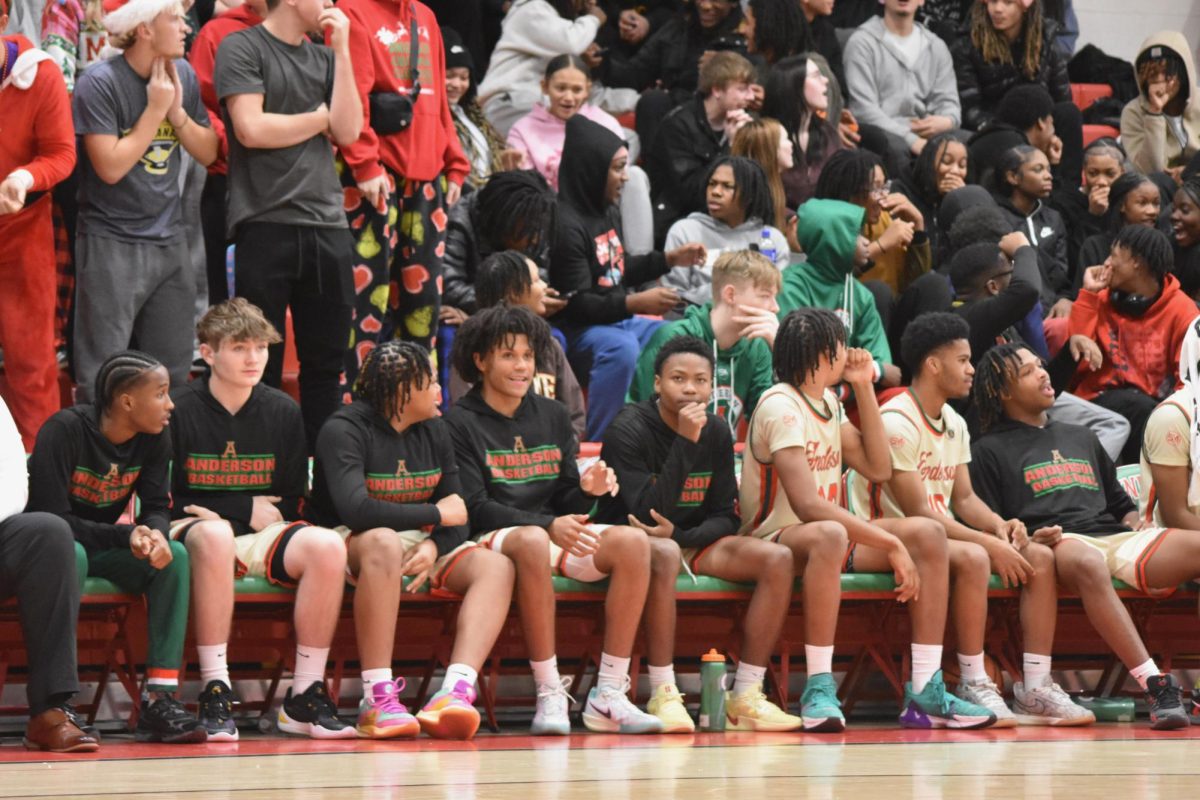 Landon Critchlow (second from right) sits with his team before a basketball game in Dec. 2024.