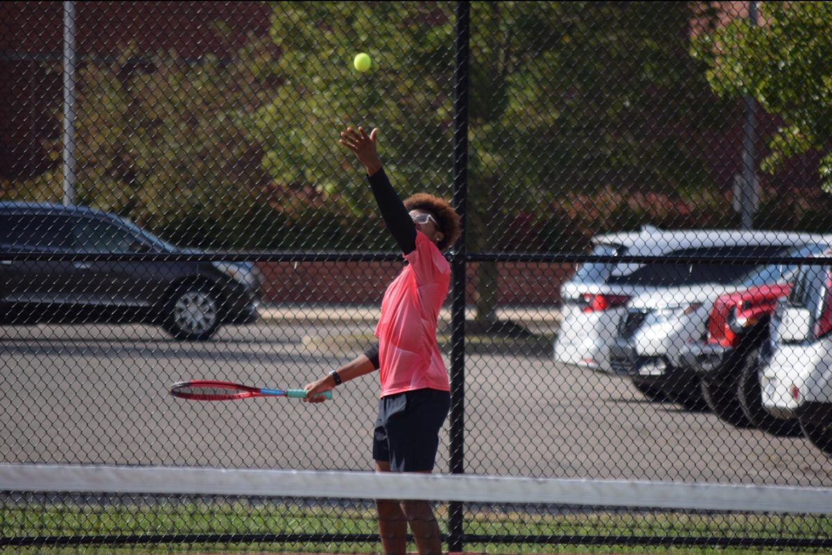 CeeJ Jones preparing to make his serve alongside his doubles partner, David Espinoza. 