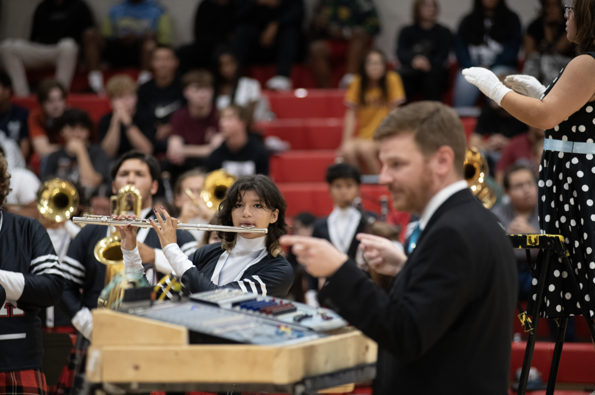 Band director Mr. Geisler conducting highlanders during pep session.