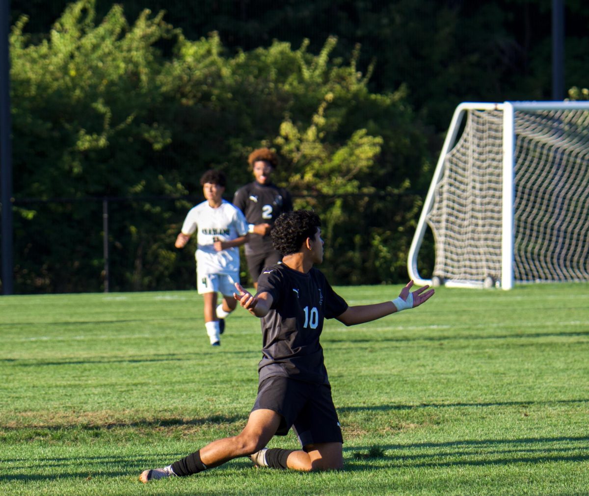 Senior Fabian Guilarte raises his hands in shock after being pushed over by a player on the opposing team. 
