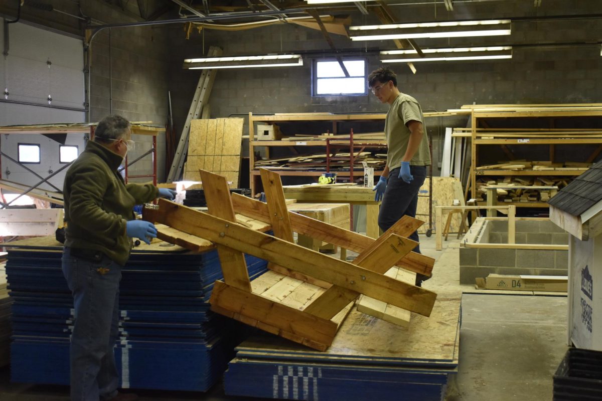 Construction teacher Esteban Briz reviews a students project at the D26 career campus. Students had a choice to in what the could create for their project, some examples being a picnic table, shelves, and treasure boxes.