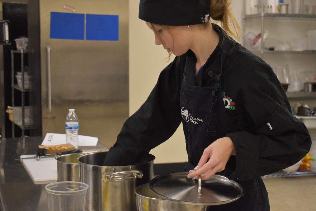 Culinary Student tries her popcorn in class at D26 Career Campus.  Students had a choice to make a variation of popcorn, such as sweet and spicy, etc.