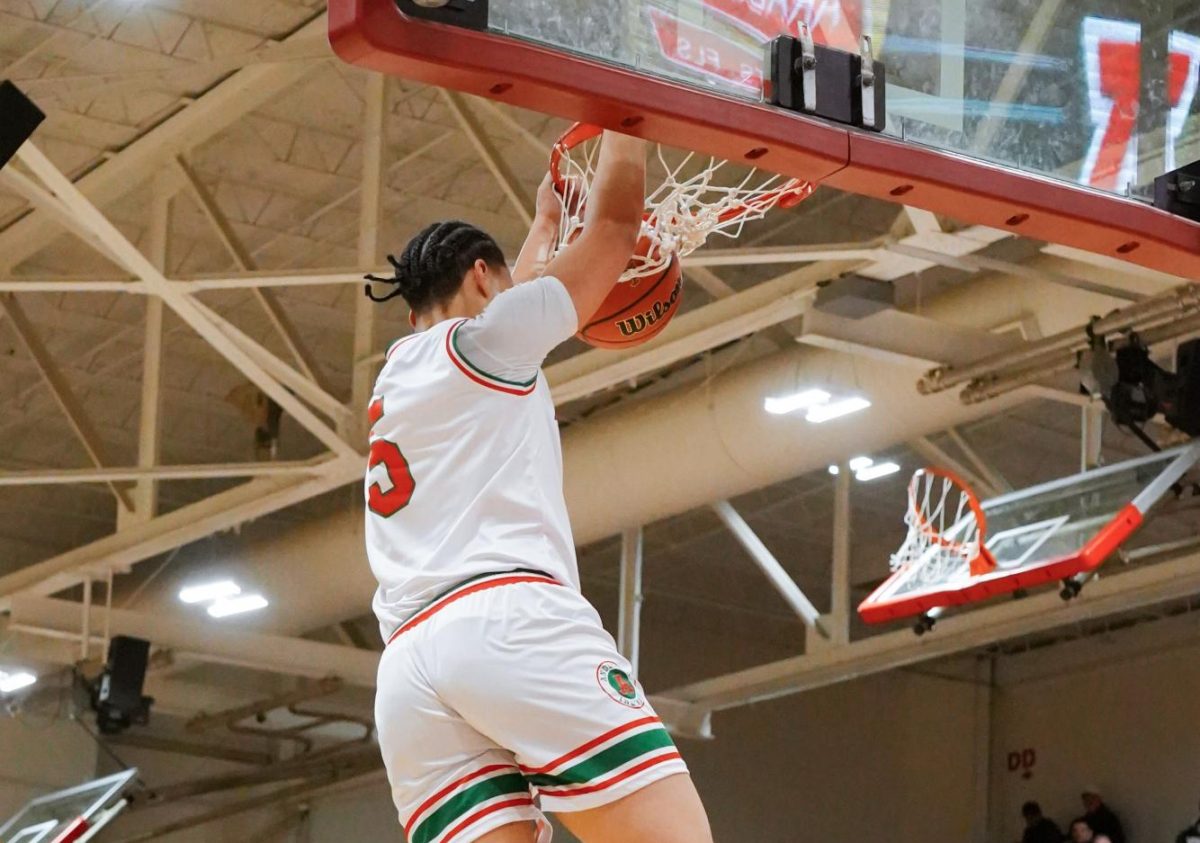 Manu Jackson dunks in the game against the Arabians.