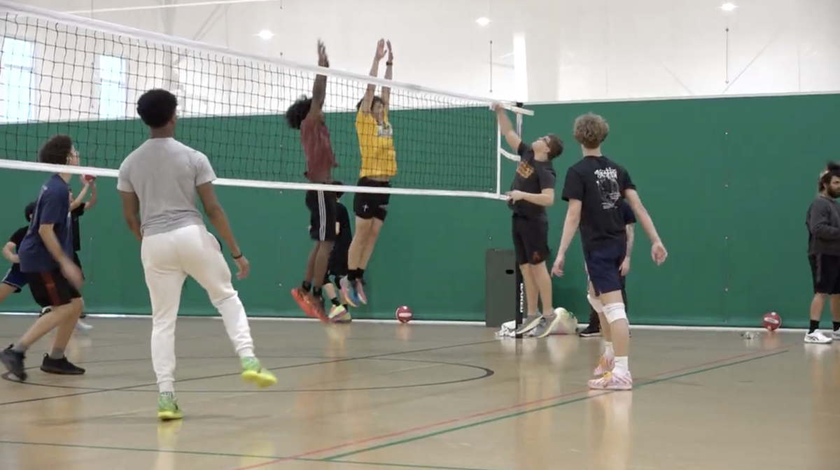 Boys run plays during a pre-season practice in the fieldhouse.